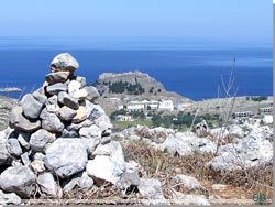Bag varden anes byen Lindos med det antikke akropolis p klippetoppen